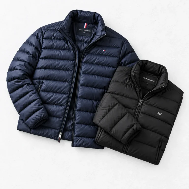 Tommy hilfiger Lightweight Packable Jacket and MICHAEL KORS Baxter Nylon Puffer Jacket arranged on a white cement background