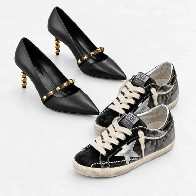 Valentino Garavani Rockstud with Sculpted Heels Pump and Golden Goose Super Star Dark Gray & Silver Velvet Sneaker arranged on a white cement background